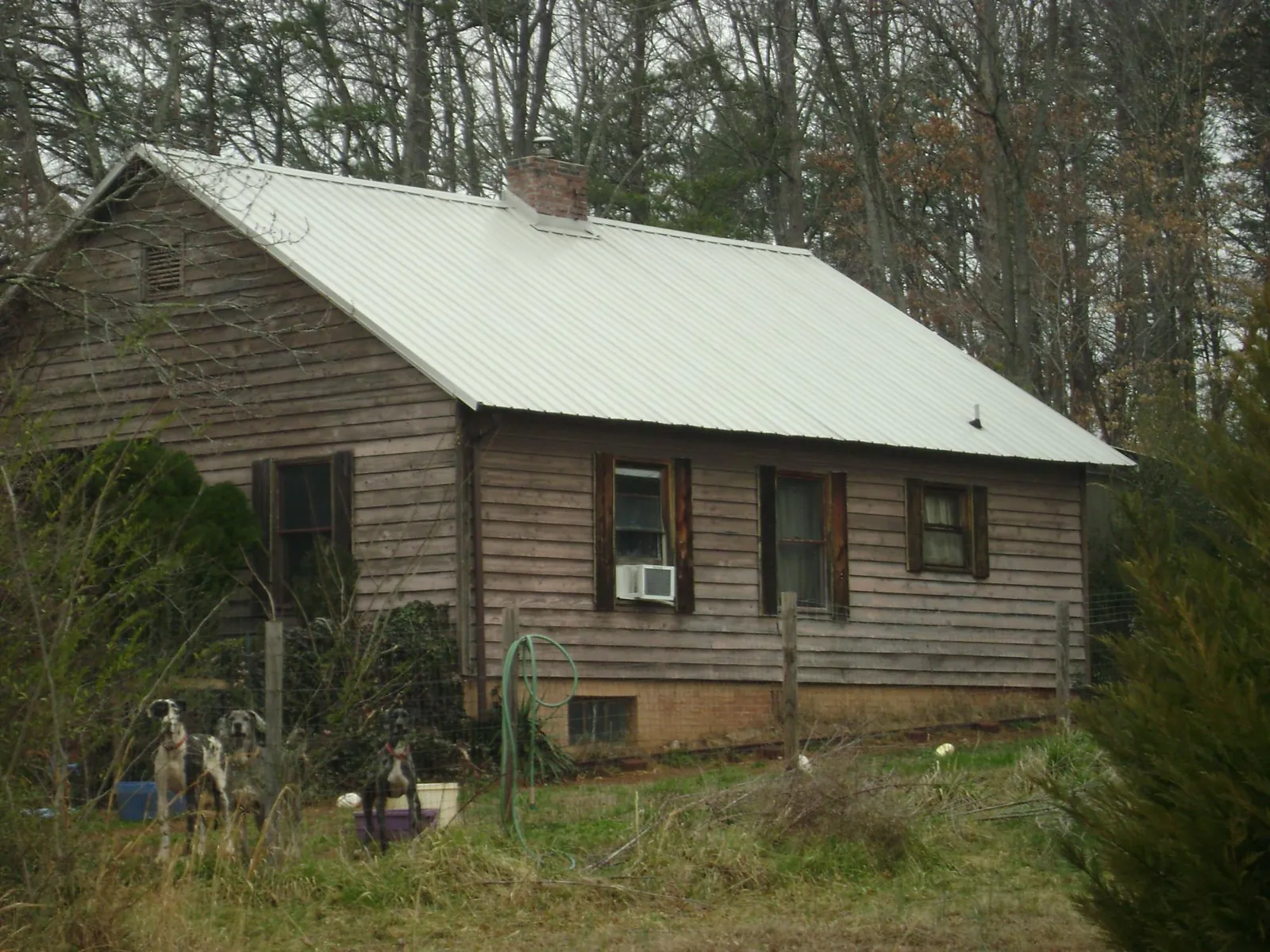 White metal roof on an old wood sided farmhouse, from a Metal Roof Installation job in Shawmut